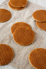 Delicious homemade dutch stroopwafels with honey-caramel filling on cloth, low angle view. Closeup.
