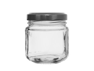 empty glass jar for jam closed by a black metal cover isolated on a white background