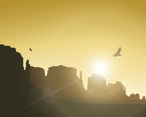 Western desert. Rocks. Flying eagles. Yellow sky. Rays of sun.