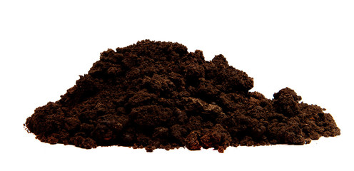 a pile of black soil on an isolated white background.