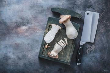 Cutting of king oyster mushroom on a board