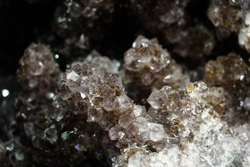 Raw cluster rough crystals close up in low light background