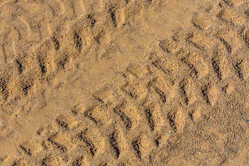 Tracks of the tires on a sand in desert