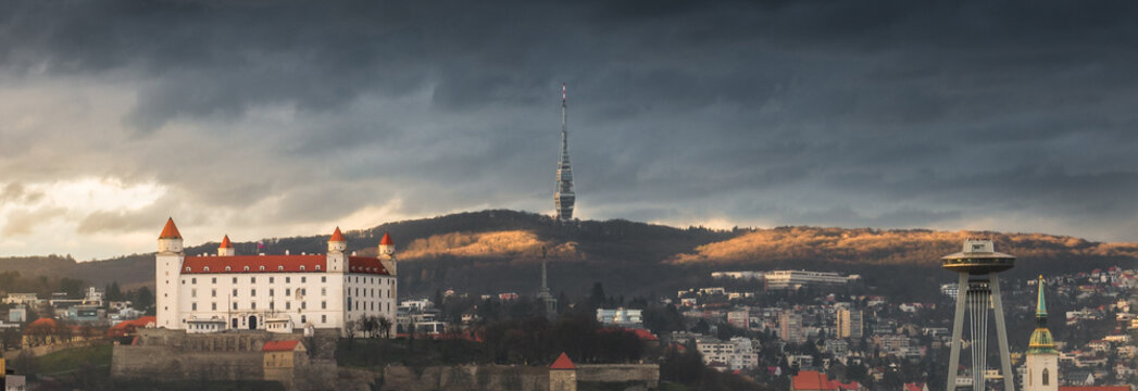 Cityscape of Bratislava with Bratislava Castle and Kamzik Television Tower on the Hill at Sunset in Slovakia