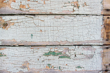 Old white cracked paint on the plank wall