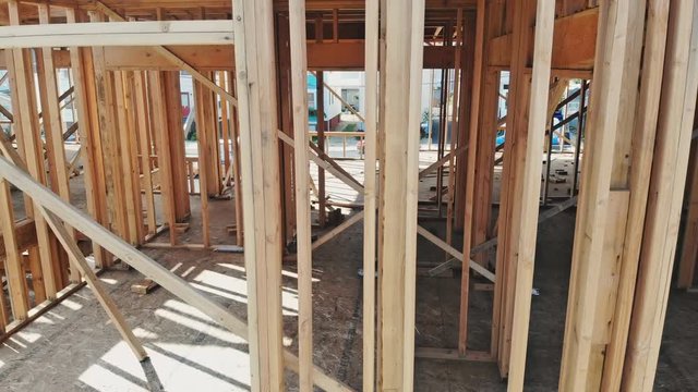 New construction of beam construction house framed the ground up framing against a blue sky