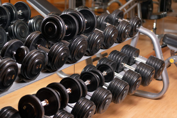 Rows of dumbbells in the gym. Fitness concept background .
