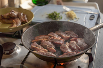 Frying juicy fresh lamb in hot cast-iron grill pan with oil