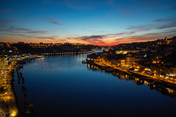 Fototapeta na wymiar Views of the Douro river and Ribeira from Dom Luis I iron bridge in a magical twilight, Porto, Portugal.
