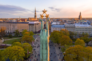 Beautiful sunset view over Riga by the statue of liberty - Milda in Latvia. The monument of...