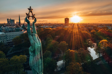 Beautiful sunset view over Riga by the statue of liberty - Milda in Latvia. The monument of...