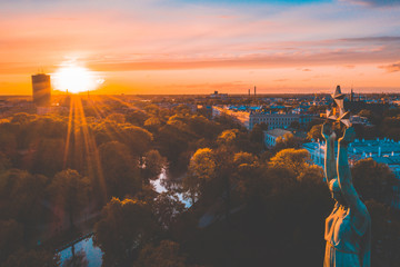 Beautiful sunset view over Riga by the statue of liberty - Milda in Latvia. The monument of...