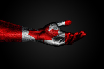 Outstretched hand with a drawn Canada flag, a sign of help or a request, on a dark background.