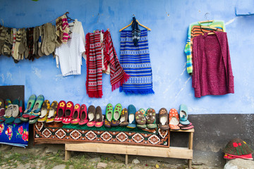 Traditional hand made woolen socks and booties for sale on the street of Viscri village in Transylvania