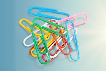 Colored paper clips isolated on white background