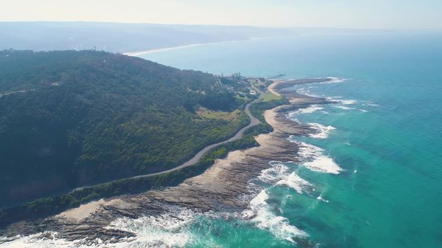 Slow rise above Great Ocean Road revealing scenic coastline