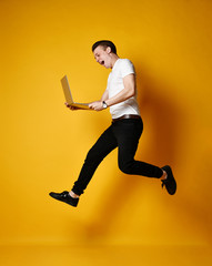 Jumping student with laptop