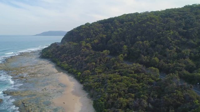 Aerial pan across rugged coastline near Great Ocean Road