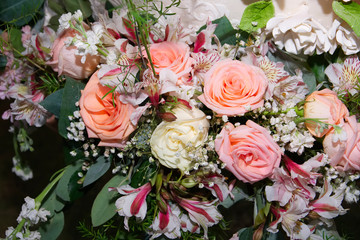 Close-up of bouquet of yellow, pink and coral roses.