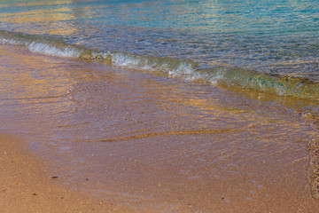 Closeup of the sand on beach and Red sea water