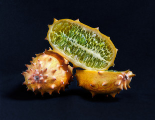 Whole and halved kiwano fruit