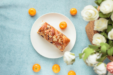 Bread, milk, fruit and flowers on the table