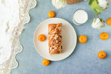 Bread, milk, fruit and flowers on the table