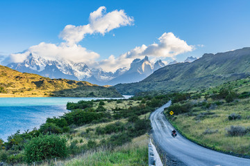 Beautiful panoramic view of stone road with aqua blue Pehoe lake and background of nature cuernos mountains peak with cloud in autumn, Torres del Paine national park, south Patagonia, Chile