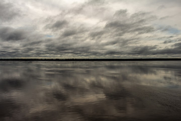 Storm clouds reflected in the waters of the river. Free space to write.