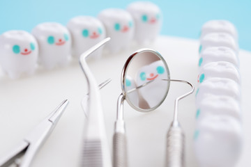 Close up.Dentist tools and smile teeth model on white background.