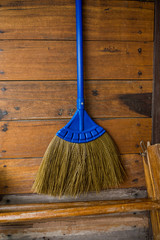Close-up of sweeping broom on wooden wall