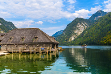 Fototapeta na wymiar Wooden old houses on the lake Koenigssee, Konigsee, Berchtesgaden National Park, Bavaria, Germany