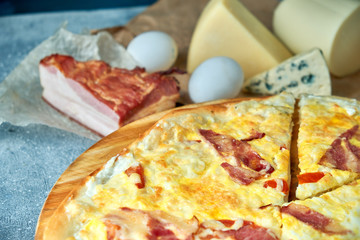 Slice of hot pizza large cheese lunch or dinner crust seafood meat topping sauce. with bell pepper vegetables delicious tasty fast food italian traditional on wooden board table classic in view