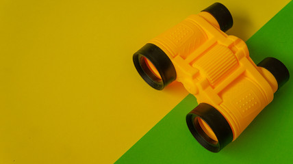 Binocular in green and yellow background