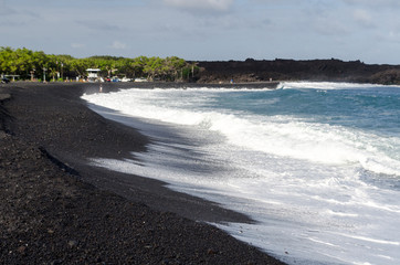 Rough surf  at edge of black sands of Pohoiki  beach