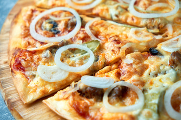 Slice of hot pizza large cheese lunch or dinner crust seafood meat topping sauce. with bell pepper vegetables delicious tasty fast food italian traditional on wooden board table classic in view