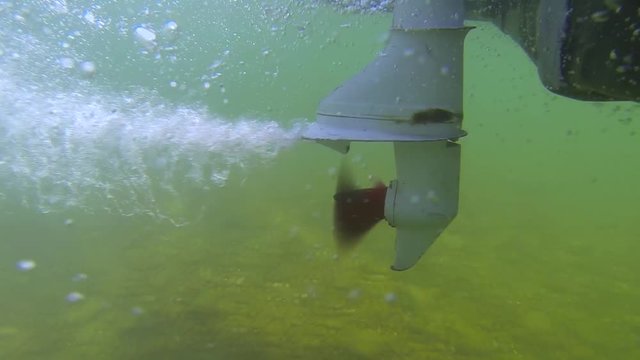 Filming the spinning propeller with gopro in the river. Very beautiful moment to film propeller in crystal clear water. Small boat driving tourists around the river. Filming in 4k 24fps