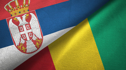 Fototapeta premium Serbia and Guinea two flags textile cloth, fabric texture