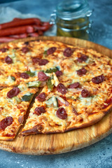 Slice of hot pizza large cheese lunch or dinner crust seafood meat topping sauce. with bell pepper vegetables delicious tasty fast food italian traditional on wooden board table classic in view