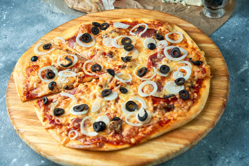 Slice of hot pizza large cheese lunch or dinner crust seafood meat topping sauce. with bell pepper vegetables delicious tasty fast food italian traditional on wooden board table classic in view