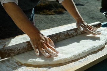 Mochi being rolled flat, before being separated into balls