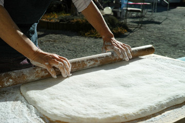 Mochi being rolled flat, before being separated into balls