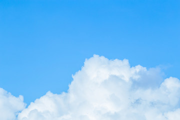 Naklejka na ściany i meble Floating white clouds and bright blue sky background