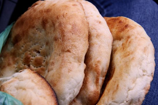white bread buns from tandyr. Tandoor pita Asian cuisine.