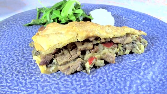 Meat pie served in a blue dish, with delicious stuffing
