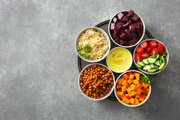 Healthy vegetarian ingredients for cooking moroccan salad. Chickpeas, Baked pumpkin and beets, quinoa and vegetables top view