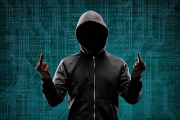 Dangerous hacker over abstract digital background with binary code. Obscured dark face in mask and...