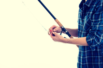 man with fishing rod and blue plaid shirt