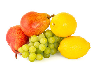 A pair of fragrant yellow lemons with a branch of ripe green grapes and bright scarlet delicious pears on a white background