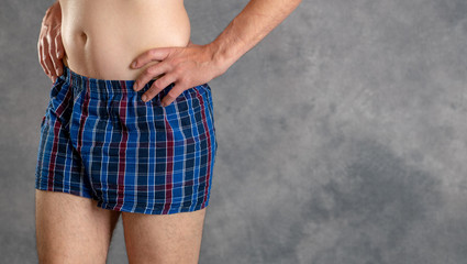 man in blue plaid boxer shorts